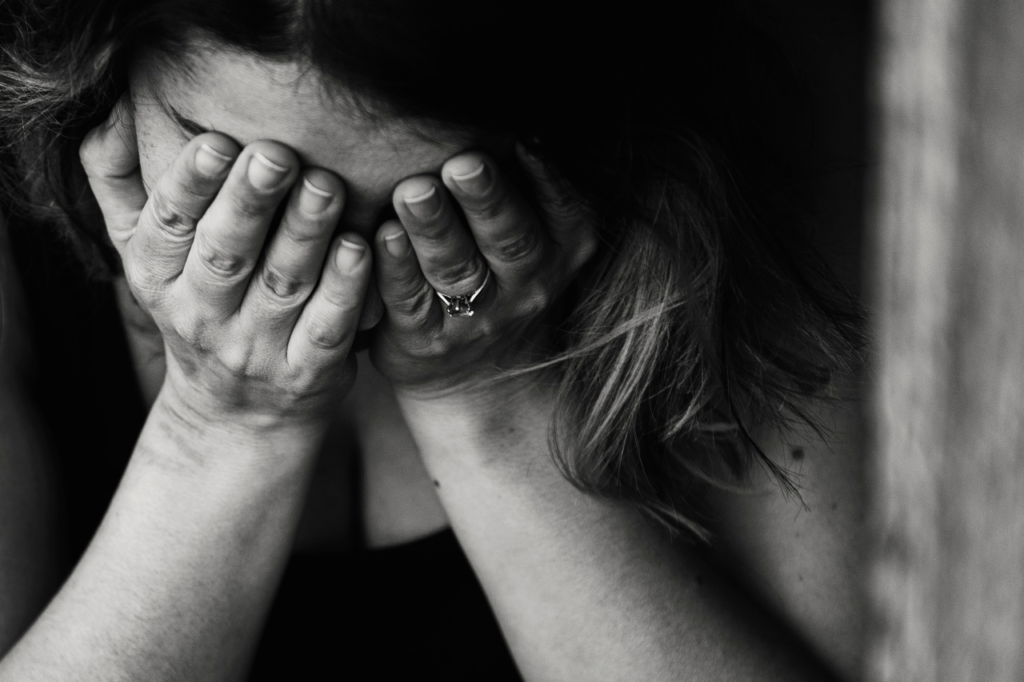 woman putting her hands over her face